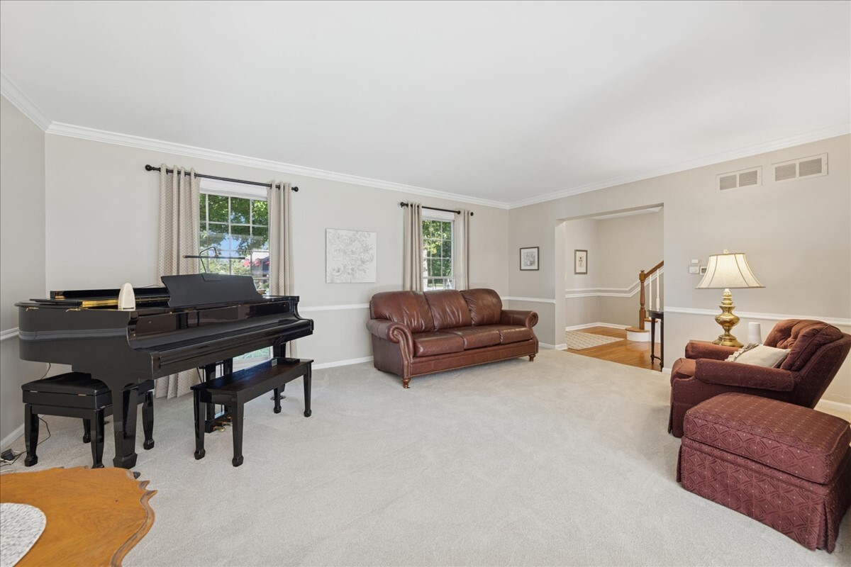 415 Hamilton Drive Wheaton, IL 60189 - Photo 7 of 27 a living room with furniture a table and a window