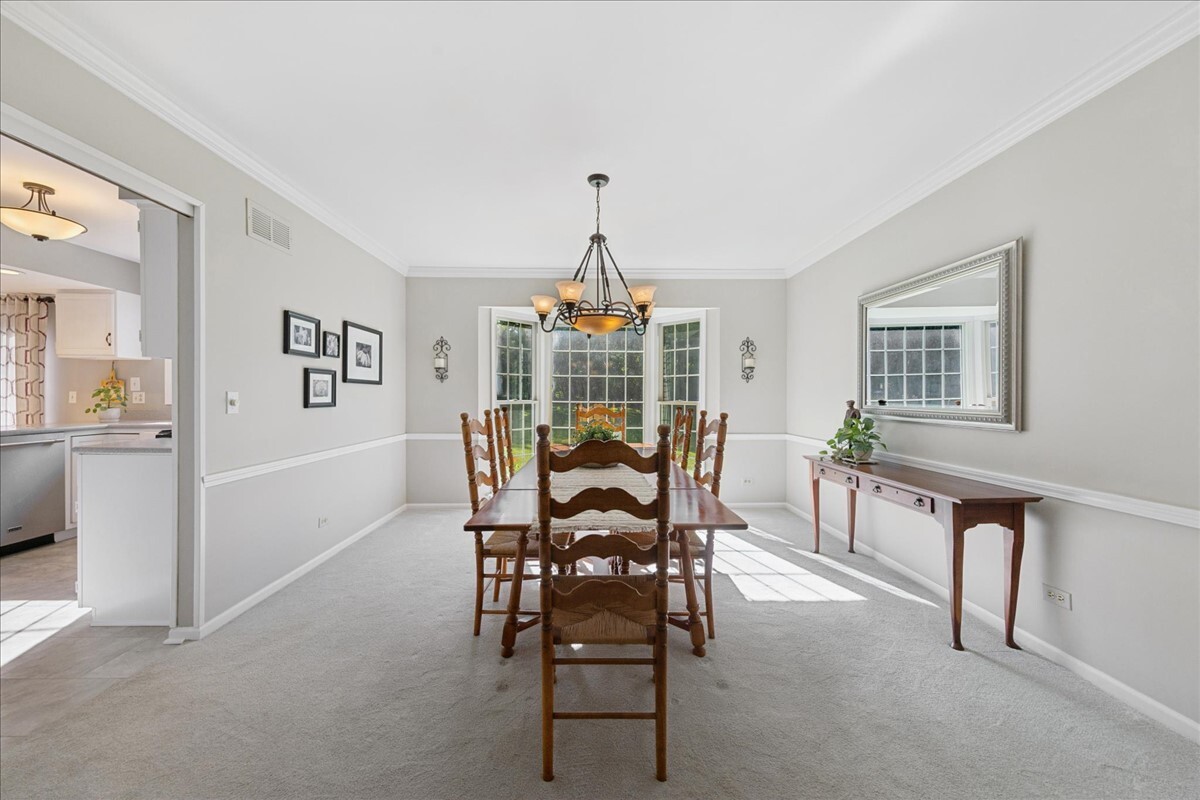 415 Hamilton Drive Wheaton, IL 60189 - Photo 8 of 27 a view of a dining room with furniture and a chandelier