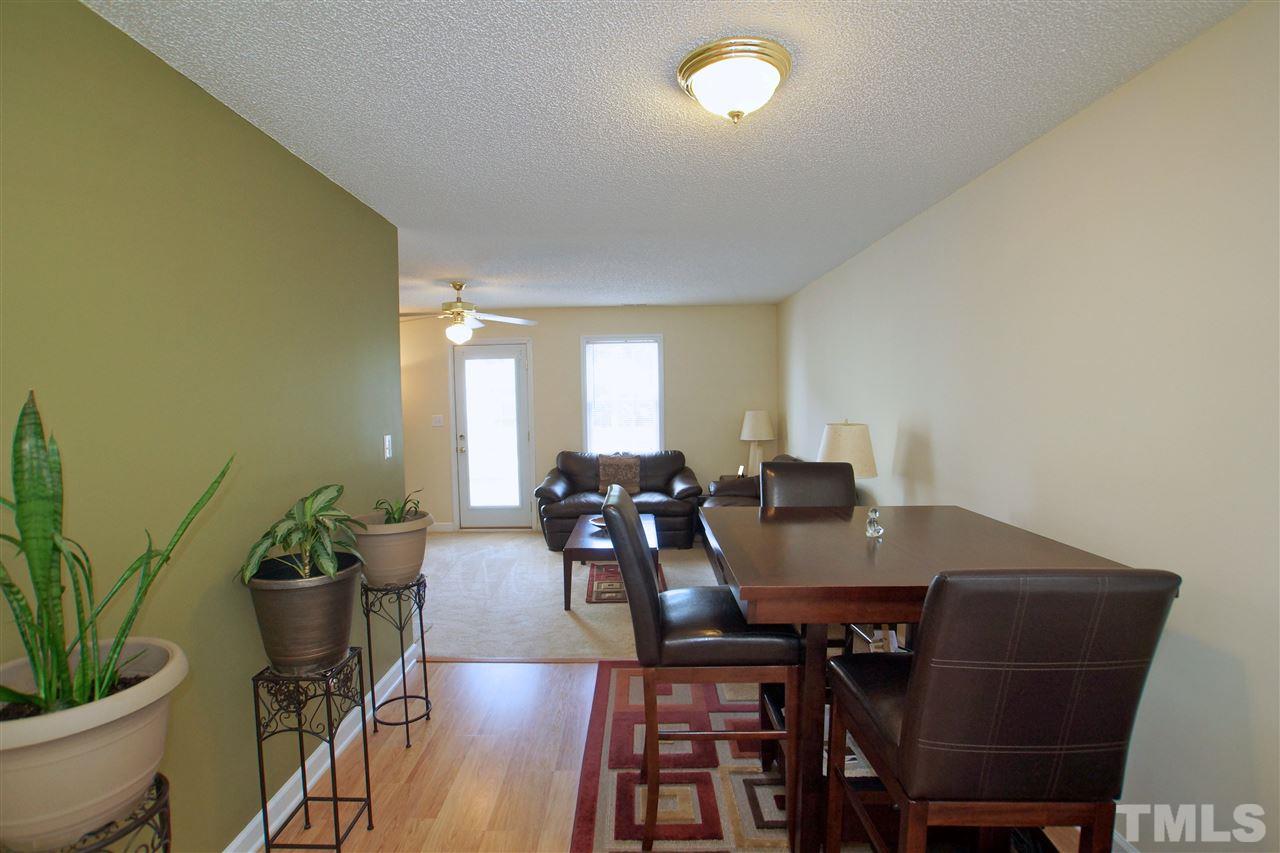 5106 Twisted Willow Way Raleigh, NC 27610 - Photo 2 of 22 a view of a dining room with furniture and wooden floor