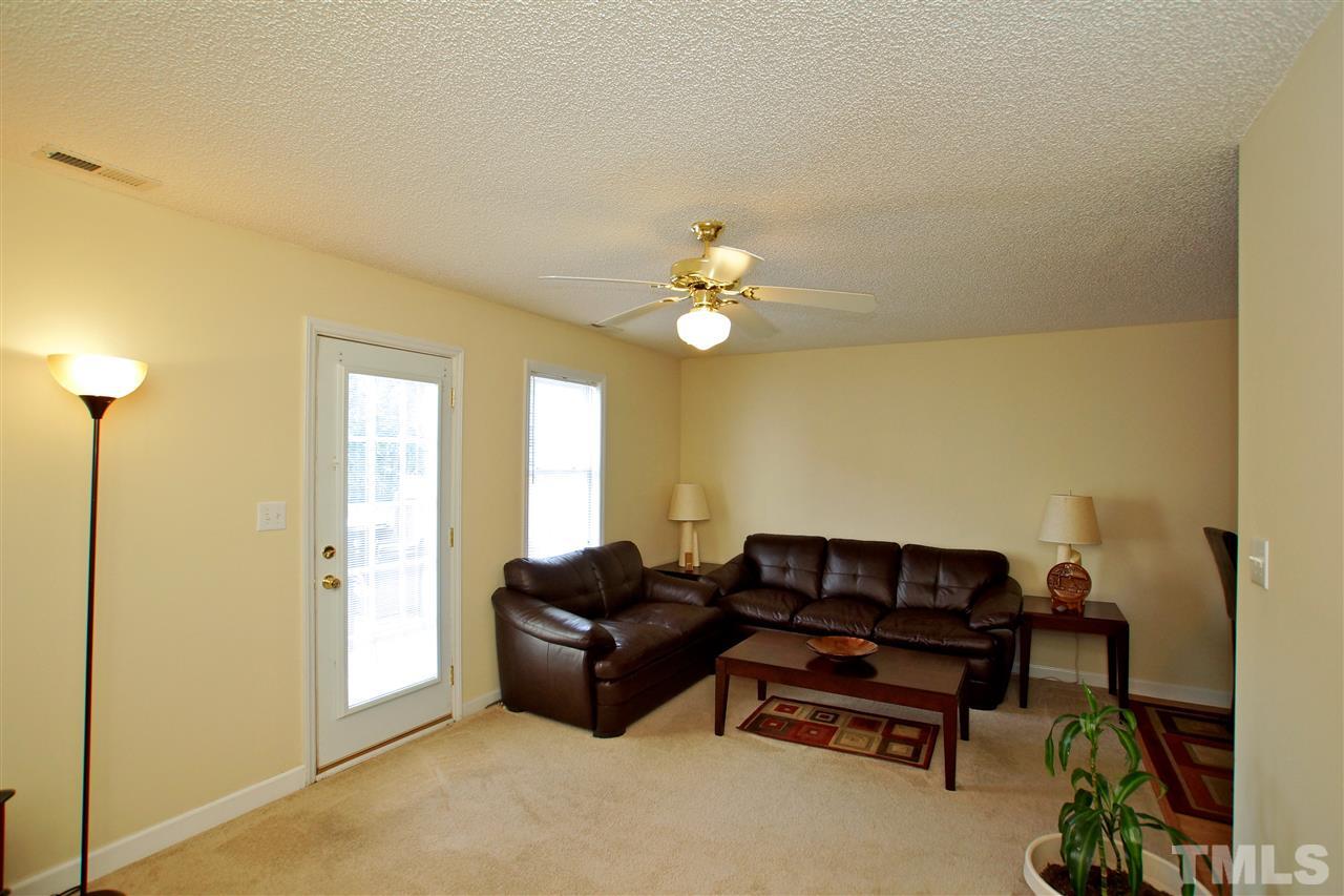 5106 Twisted Willow Way Raleigh, NC 27610 - Photo 11 of 22 a living room with furniture and a chandelier