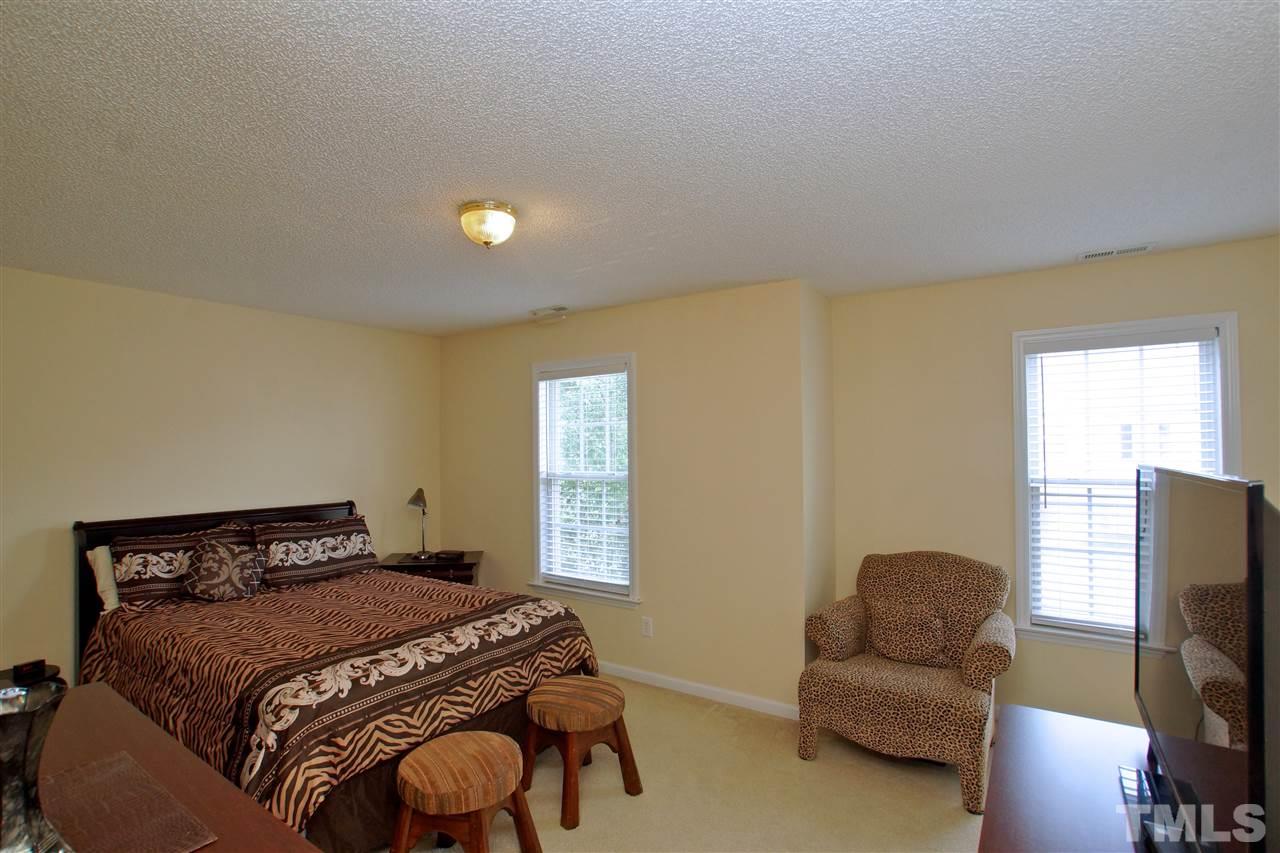 5106 Twisted Willow Way Raleigh, NC 27610 - Photo 15 of 22 a bedroom with a bed and a couch