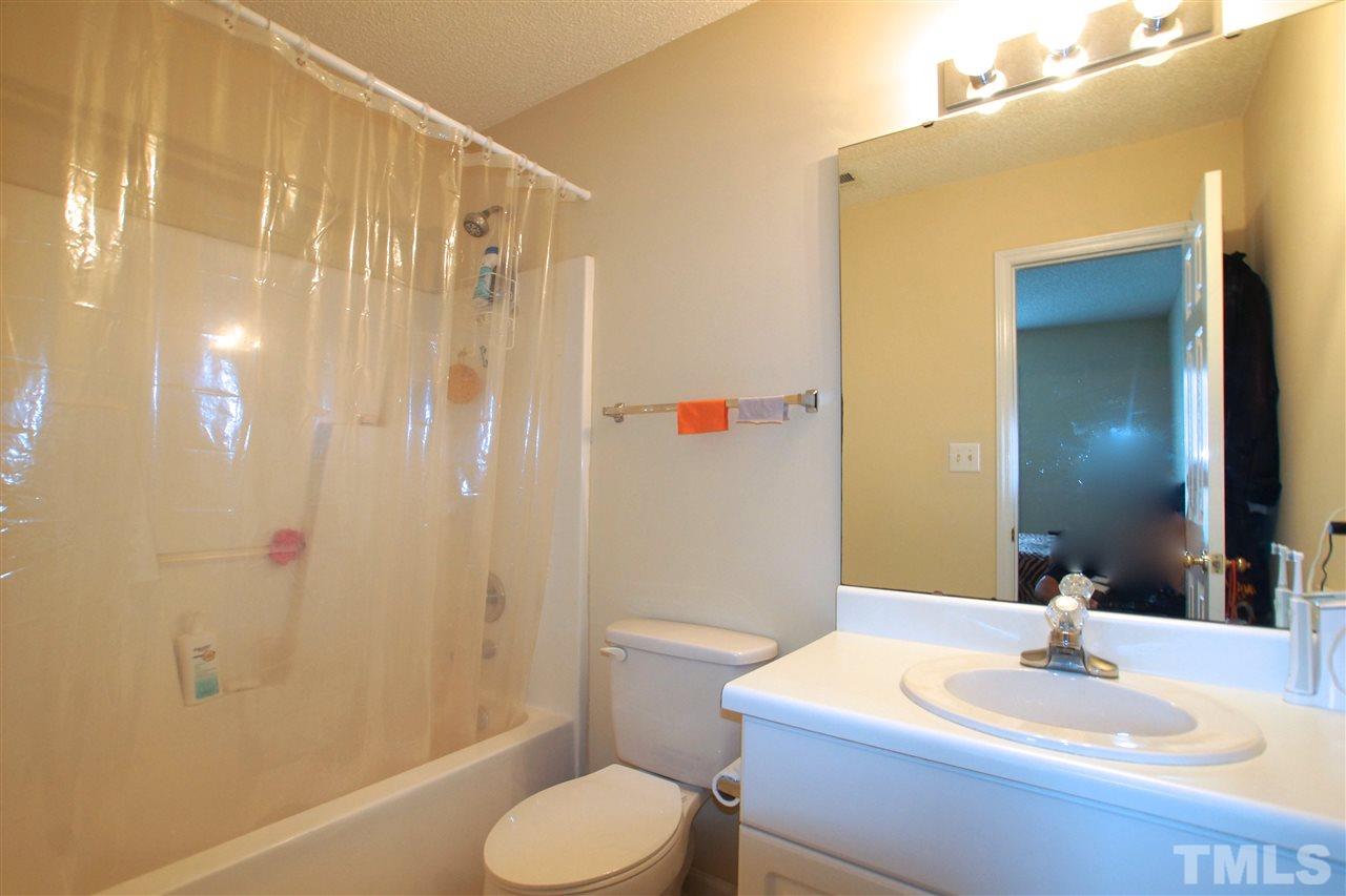 5106 Twisted Willow Way Raleigh, NC 27610 - Photo 16 of 22 a bathroom with a sink toilet and shower