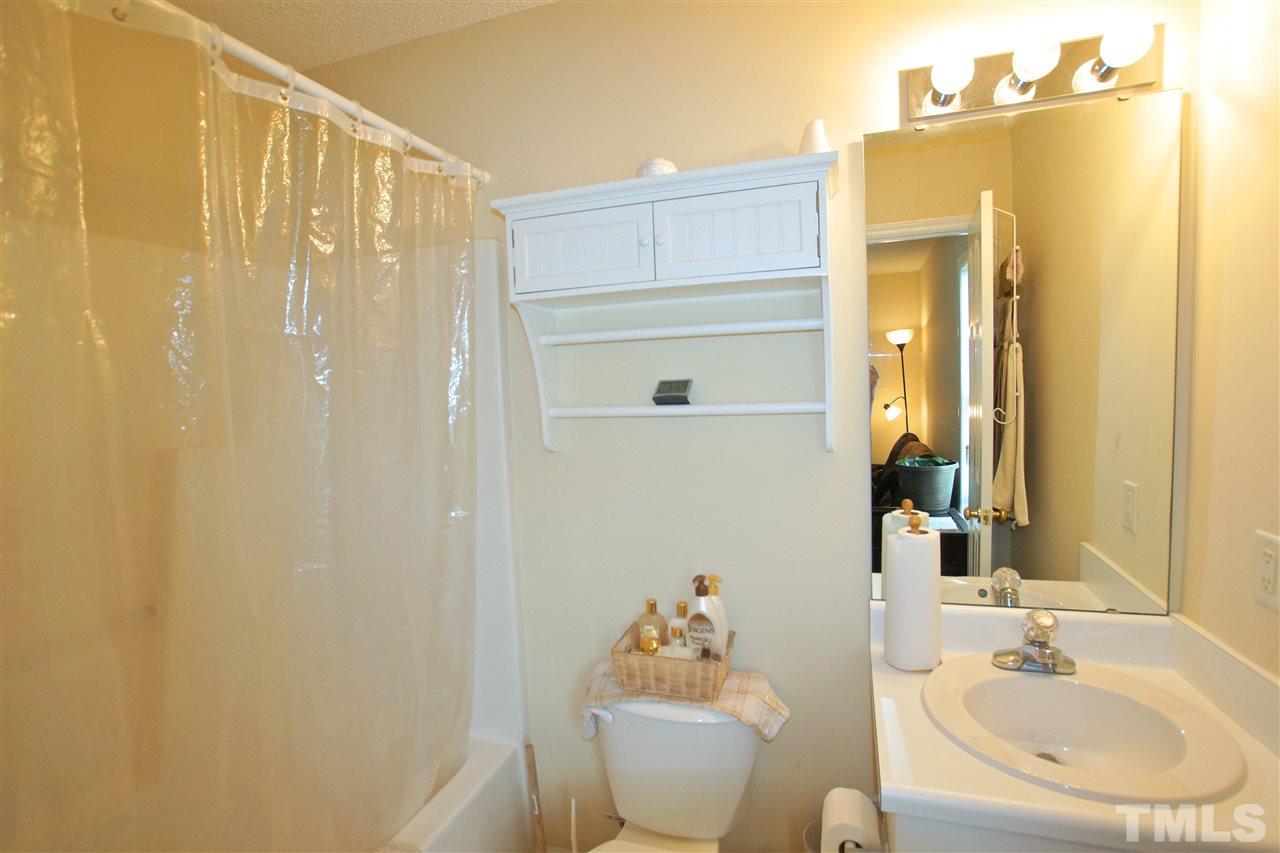 5106 Twisted Willow Way Raleigh, NC 27610 - Photo 18 of 22 a bathroom with a sink a toilet and shower curtain