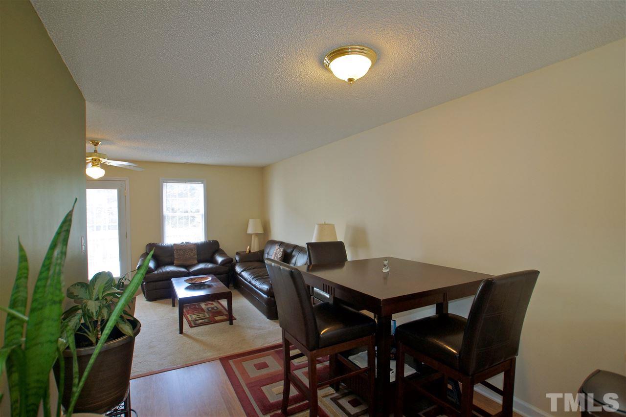 5106 Twisted Willow Way Raleigh, NC 27610 - Photo 3 of 22 a view of a dining room with furniture and wooden floor