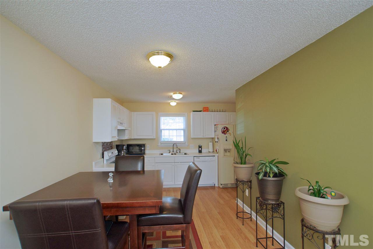 5106 Twisted Willow Way Raleigh, NC 27610 - Photo 4 of 22 a view of a dining room with furniture and a potted plant