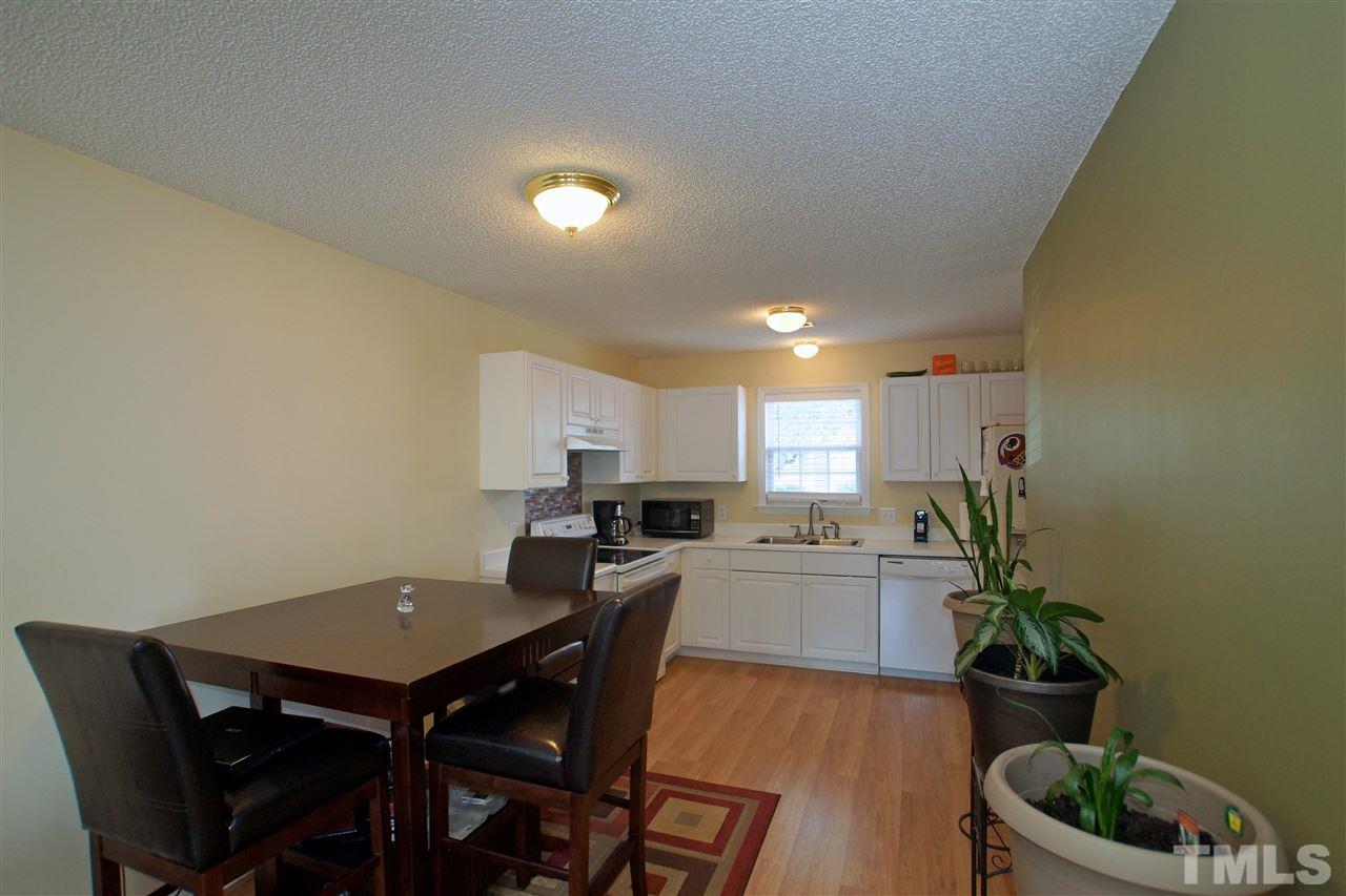 5106 Twisted Willow Way Raleigh, NC 27610 - Photo 5 of 22 a kitchen with a table and chairs in it
