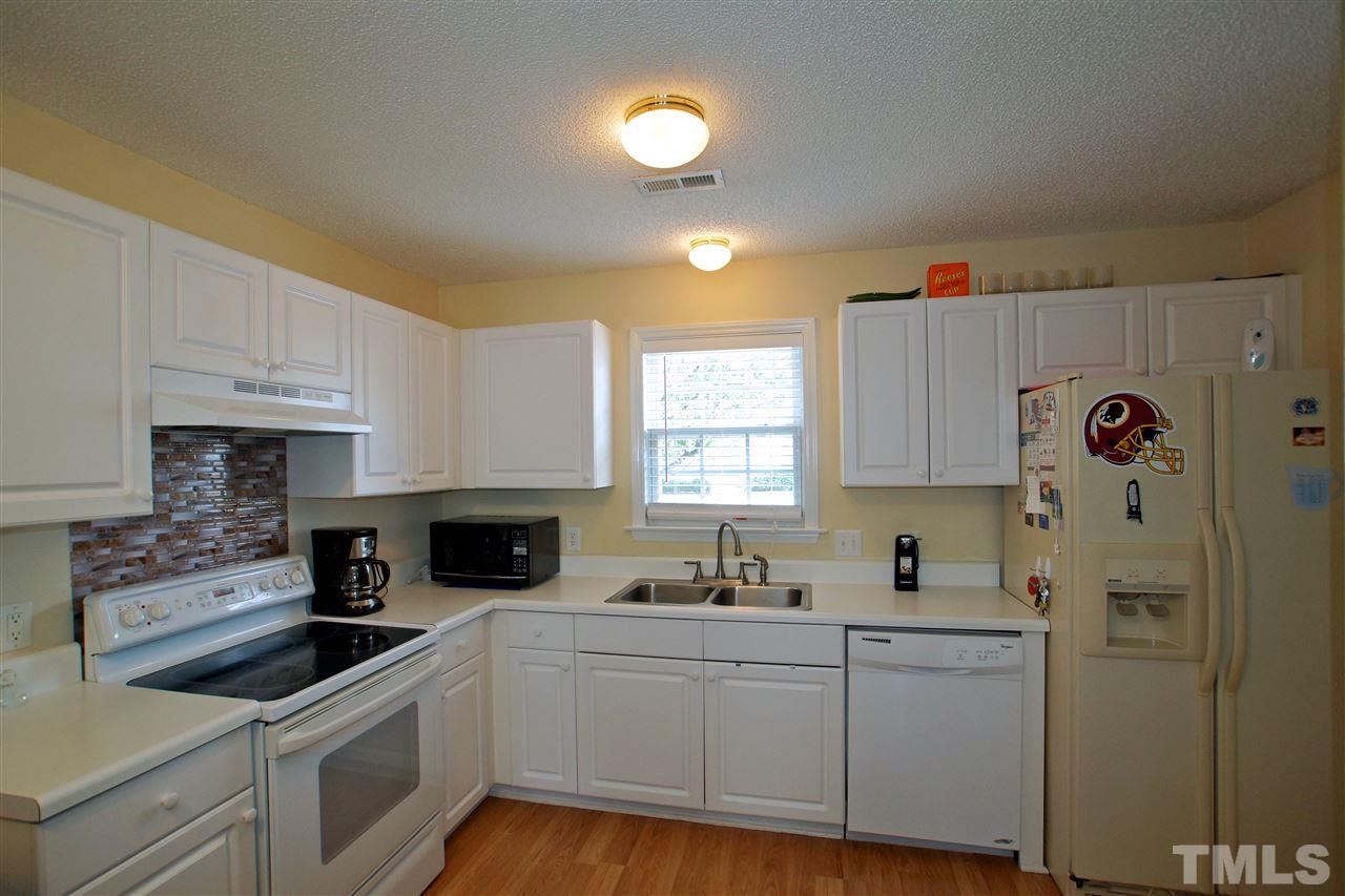5106 Twisted Willow Way Raleigh, NC 27610 - Photo 6 of 22 a kitchen with a sink cabinets and window