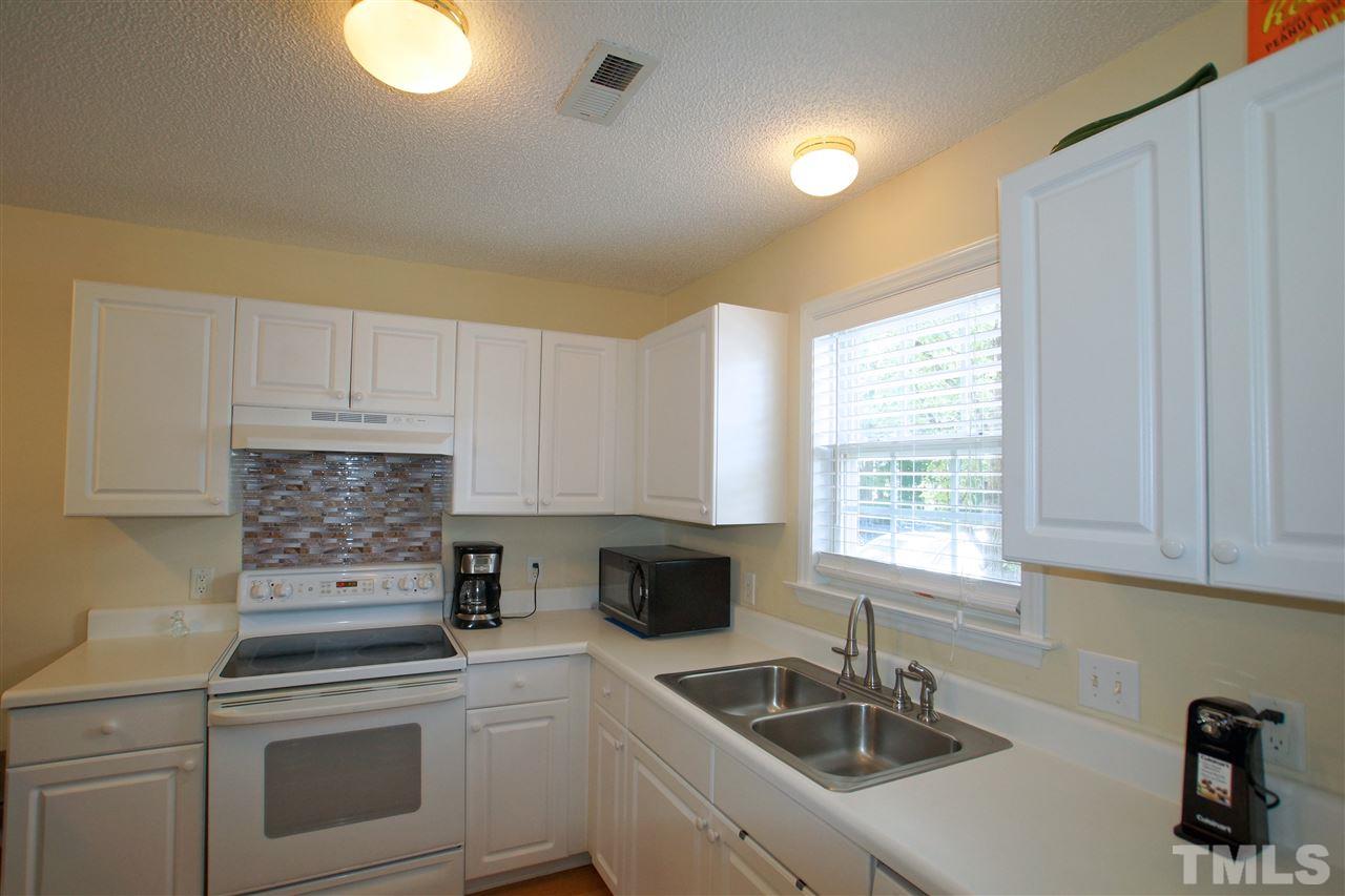 5106 Twisted Willow Way Raleigh, NC 27610 - Photo 7 of 22 a kitchen with a sink cabinets and window
