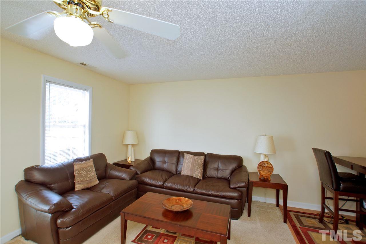 5106 Twisted Willow Way Raleigh, NC 27610 - Photo 10 of 22 a living room with furniture a couch and chandelier