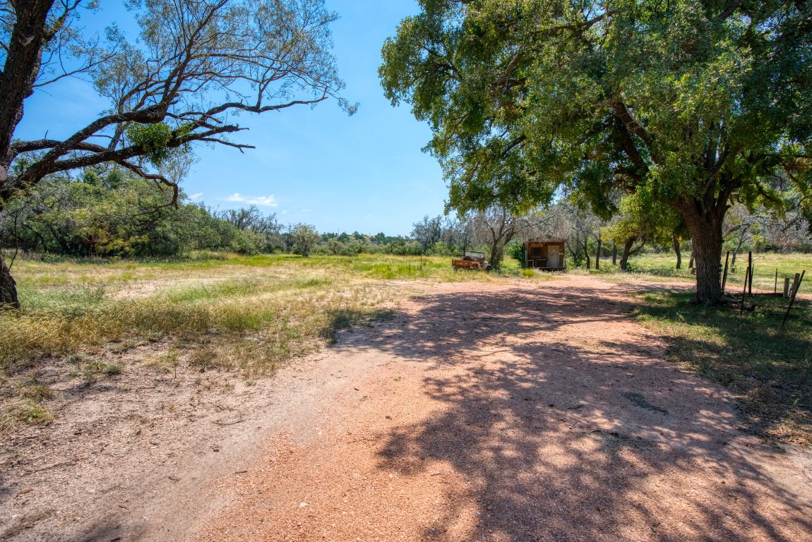 51 D S Road Fredericksburg, TX 78624 - Photo 6 of 19 a view of a lake with beach and large trees