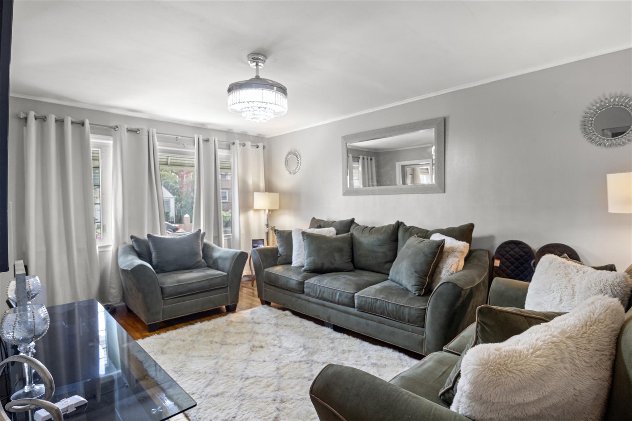 239-15 147th Road Queens, NY 11422 - Photo 12 of 28 Living area with crown molding and wood finished floors