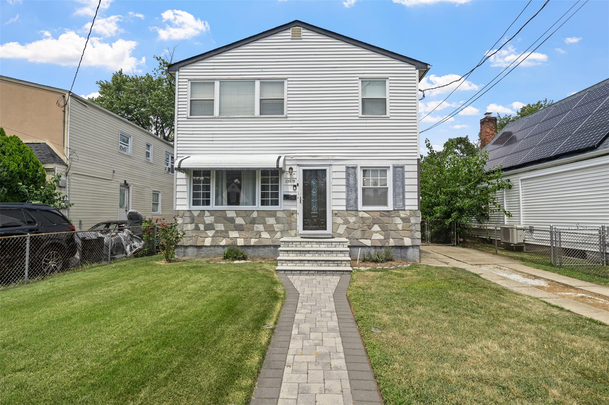 239-15 147th Road Queens, NY 11422 - Photo 24 of 28 View of front facade with stone siding and entry steps