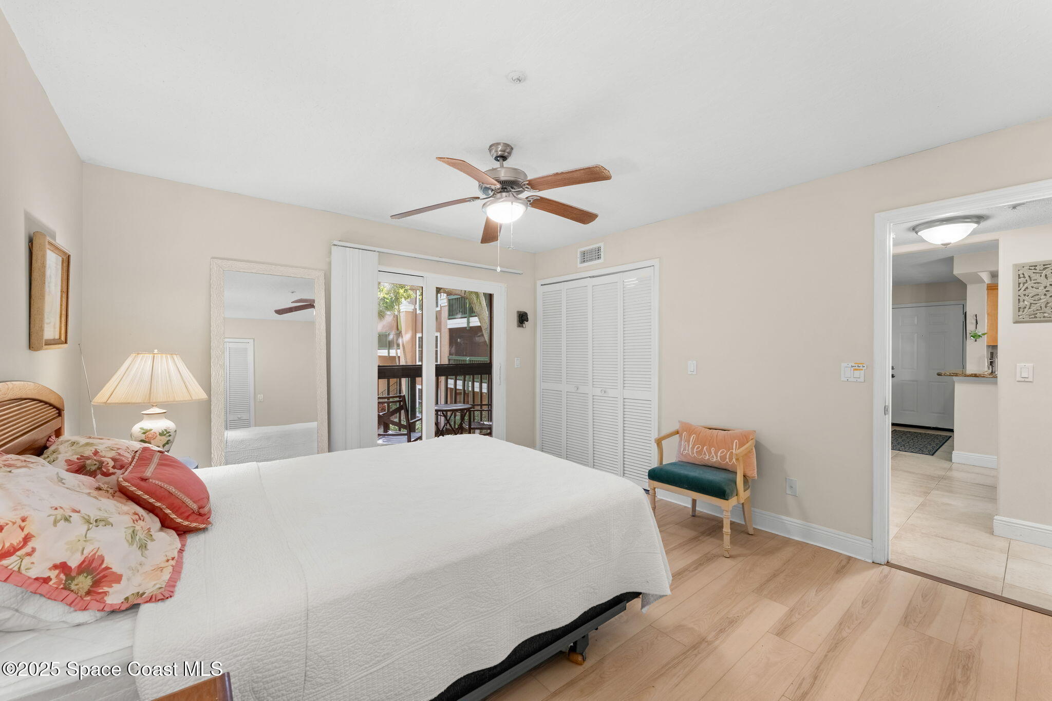 7667 North Wickham Road, Unit 514 Melbourne, FL 32940 - Photo 12 of 37 a bedroom with a bed and a chandelier