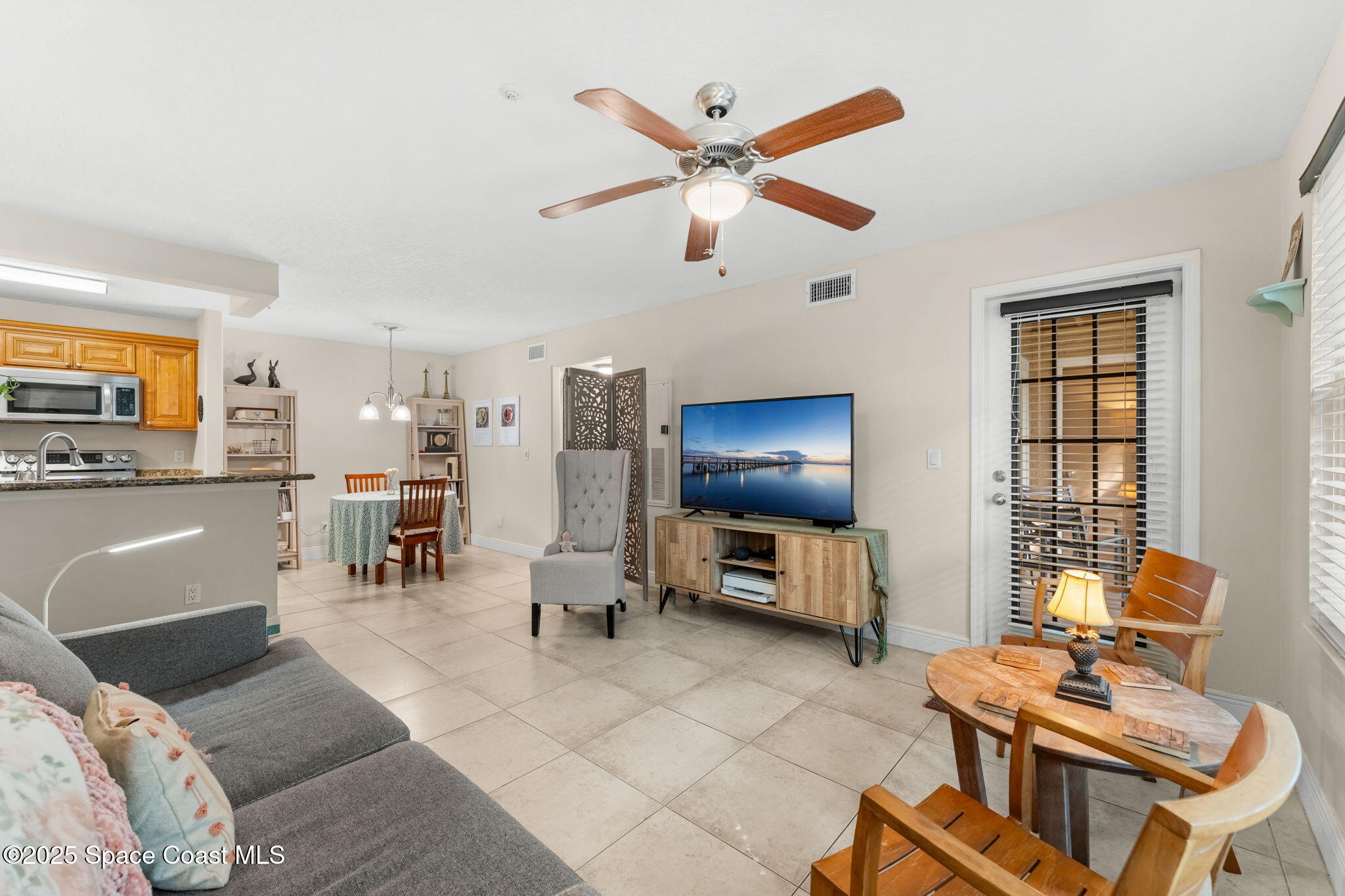 7667 North Wickham Road, Unit 514 Melbourne, FL 32940 - Photo 14 of 37 a living room with furniture and a flat screen tv