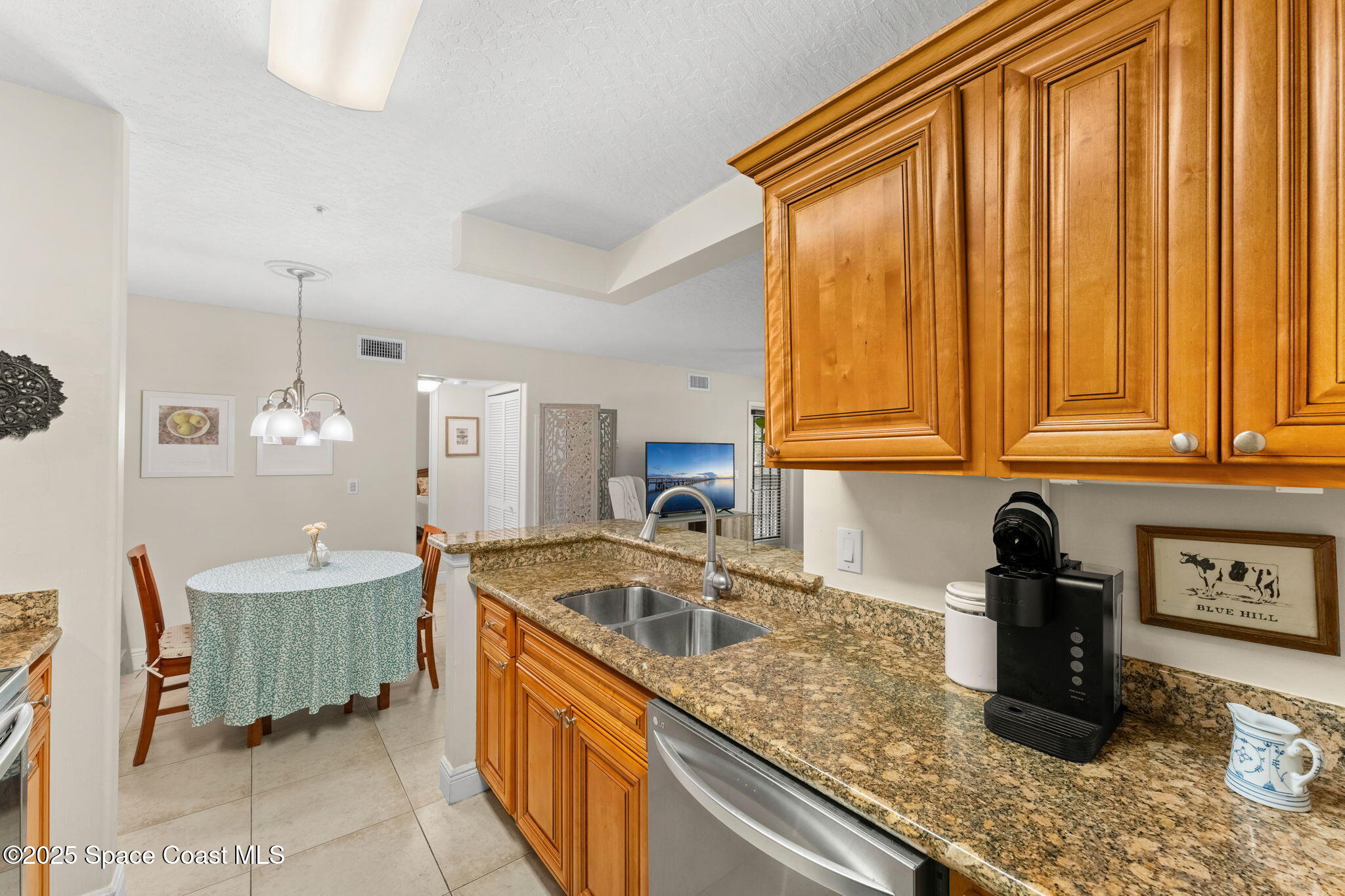 7667 North Wickham Road, Unit 514 Melbourne, FL 32940 - Photo 15 of 37 a kitchen with granite countertop a sink a stove and cabinets