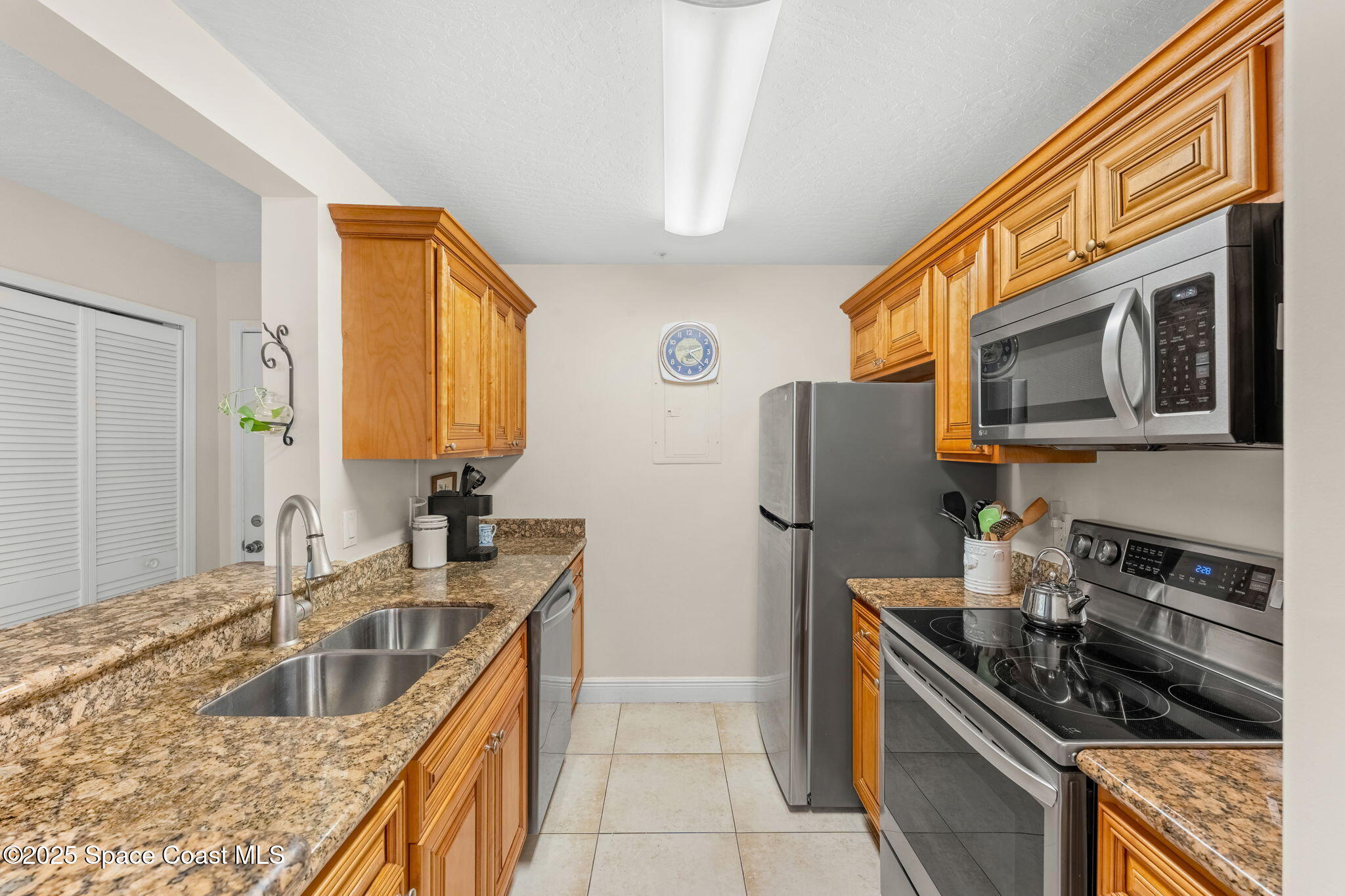 7667 North Wickham Road, Unit 514 Melbourne, FL 32940 - Photo 16 of 37 a kitchen with stainless steel appliances granite countertop a sink stove and refrigerator