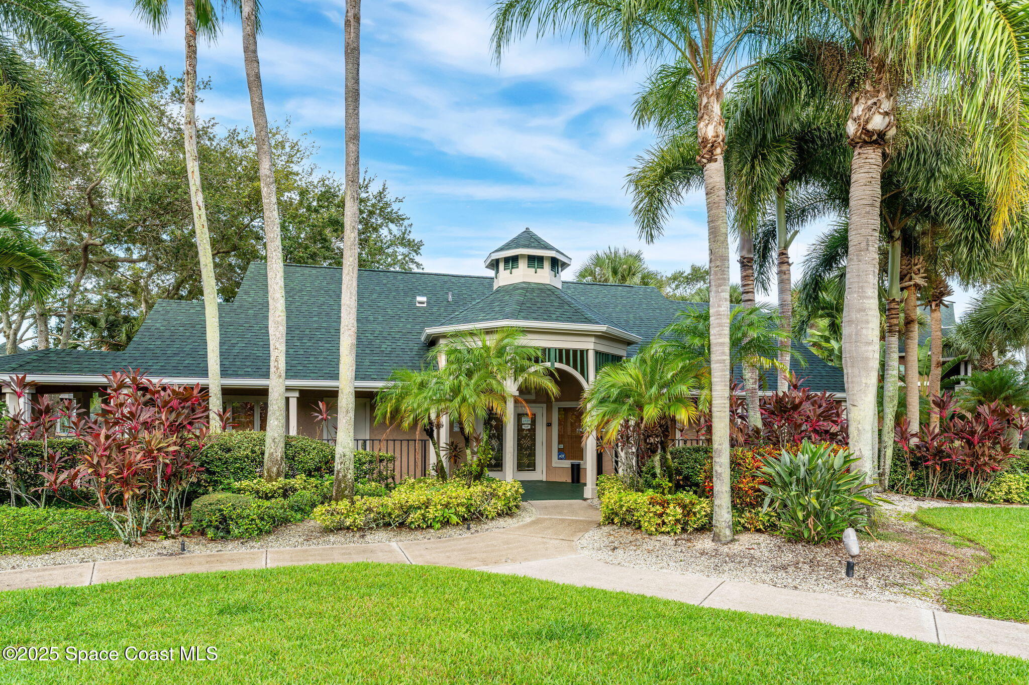 7667 North Wickham Road, Unit 514 Melbourne, FL 32940 - Photo 23 of 37 a front view of a house with a garden