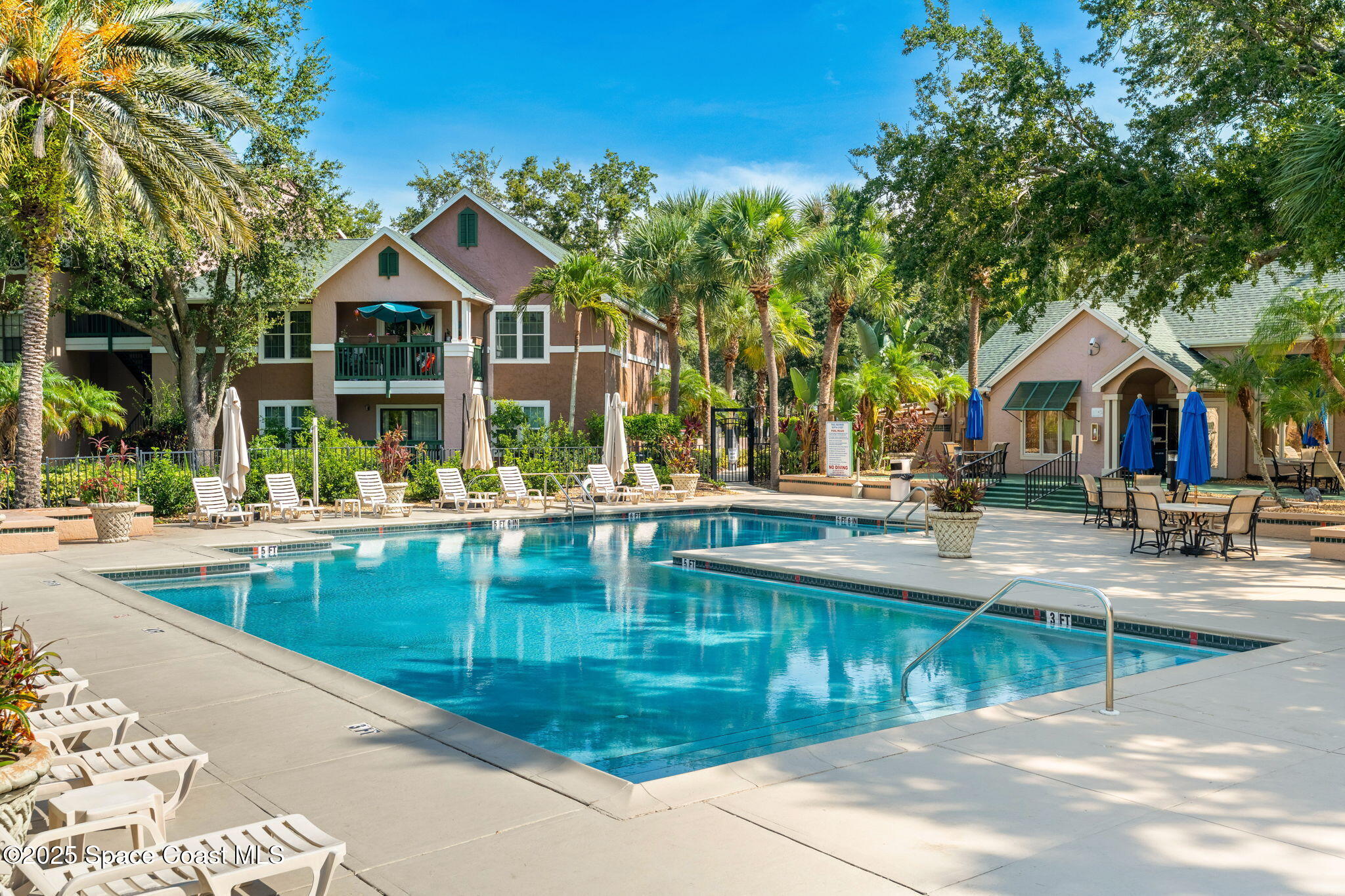 7667 North Wickham Road, Unit 514 Melbourne, FL 32940 - Photo 27 of 37 a view of a house with pool and chairs