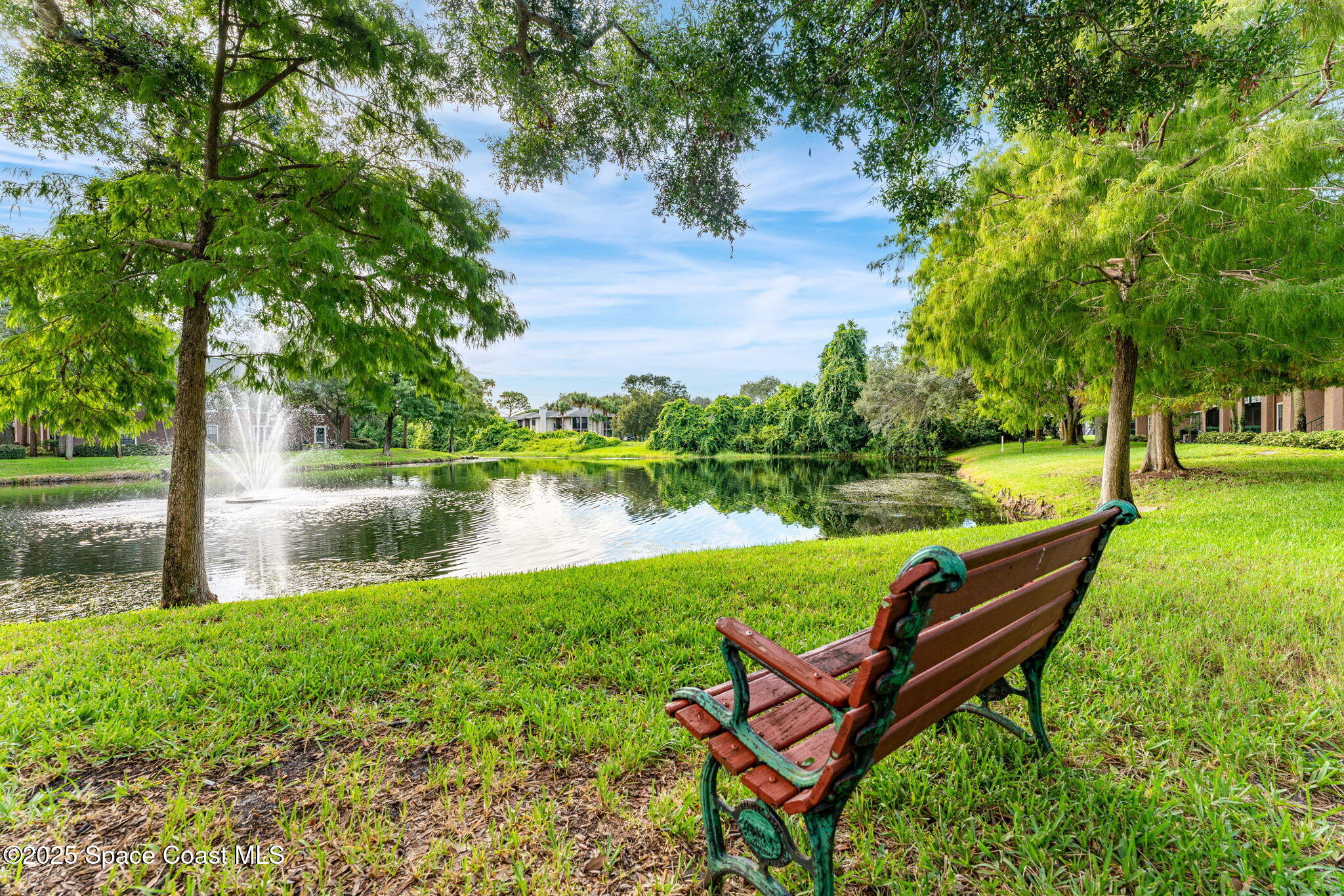 7667 North Wickham Road, Unit 514 Melbourne, FL 32940 - Photo 29 of 37 a backyard of a house with table and chairs
