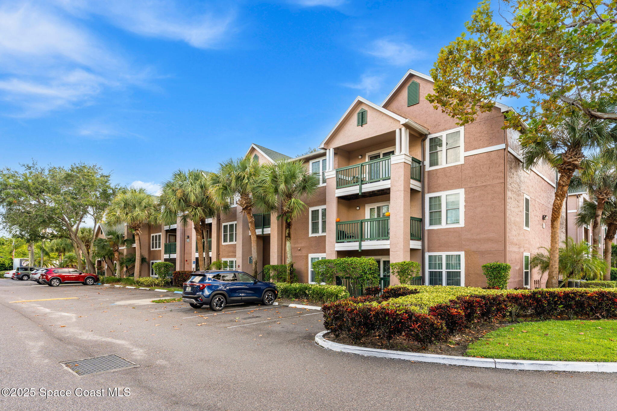 7667 North Wickham Road, Unit 514 Melbourne, FL 32940 - Photo 35 of 37 a couple of cars parked in front of a building
