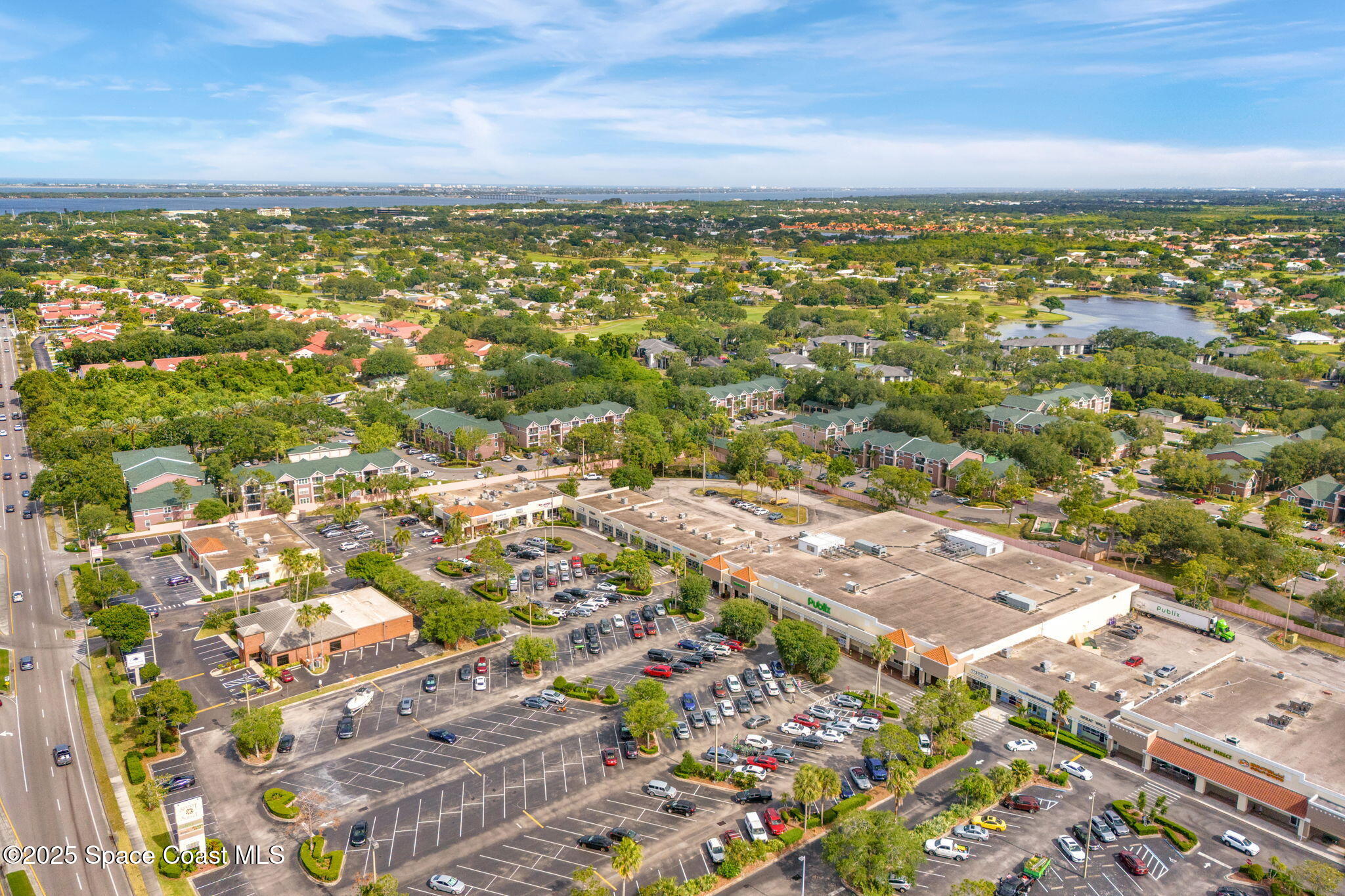 7667 North Wickham Road, Unit 514 Melbourne, FL 32940 - Photo 36 of 37 an aerial view of residential building with outdoor space