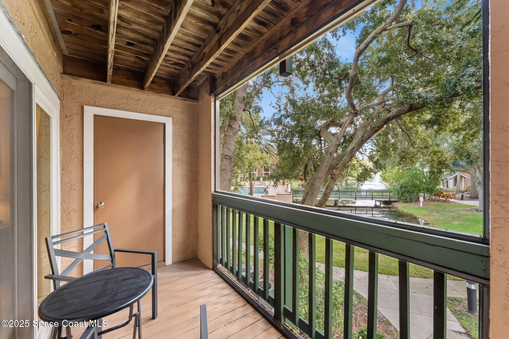 7667 North Wickham Road, Unit 514 Melbourne, FL 32940 - Photo 4 of 37 a view of a porch with furniture and a yard