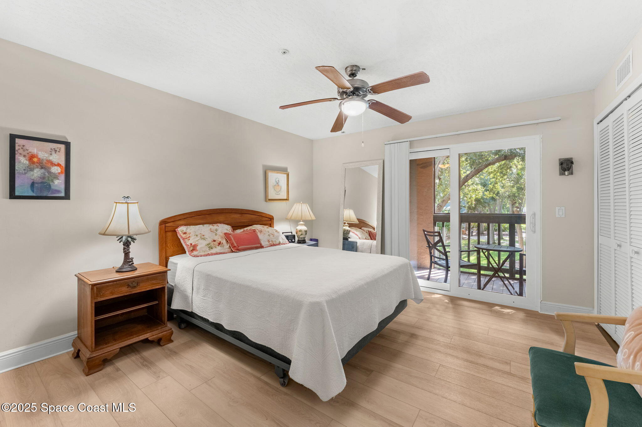 7667 North Wickham Road, Unit 514 Melbourne, FL 32940 - Photo 5 of 37 a bed room with a bed and a chandelier