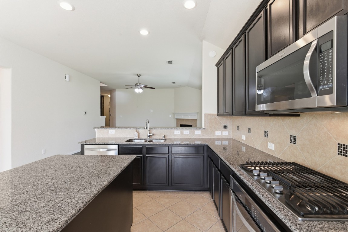 3418 Delta Drive Rosharon, TX 77583 - Photo 14 of 38 a kitchen with stainless steel appliances granite countertop a sink stove and cabinets