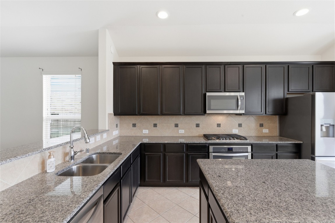 3418 Delta Drive Rosharon, TX 77583 - Photo 15 of 38 a kitchen with kitchen island stainless steel appliances a sink stove and refrigerator