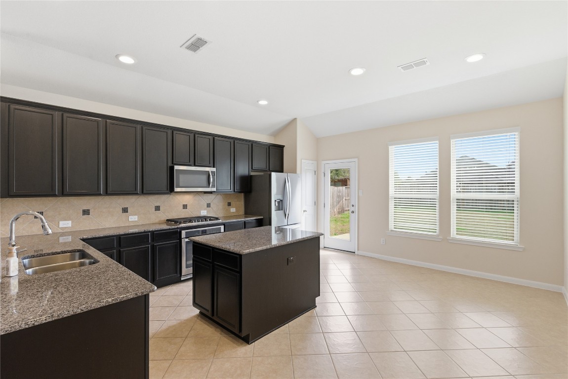 3418 Delta Drive Rosharon, TX 77583 - Photo 16 of 38 a kitchen with stainless steel appliances granite countertop a sink stove and refrigerator