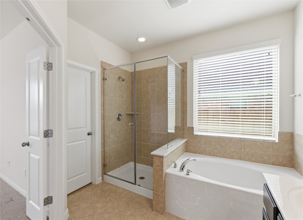 3418 Delta Drive Rosharon, TX 77583 - Photo 20 of 38 a bathroom with a bath tub a shower and a window
