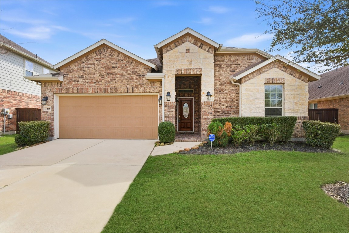 3418 Delta Drive Rosharon, TX 77583 - Photo 4 of 38 a front view of a house with a yard and garage