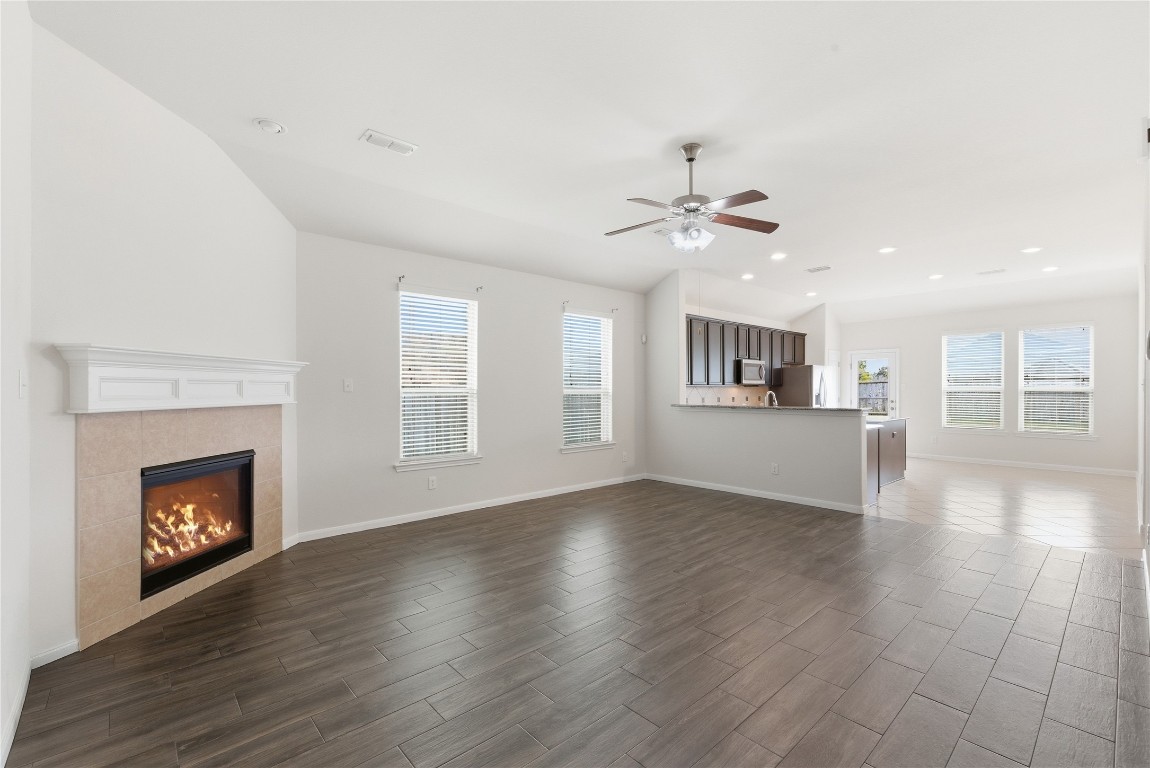 3418 Delta Drive Rosharon, TX 77583 - Photo 8 of 38 a view of an empty room with wooden floor fireplace and a window