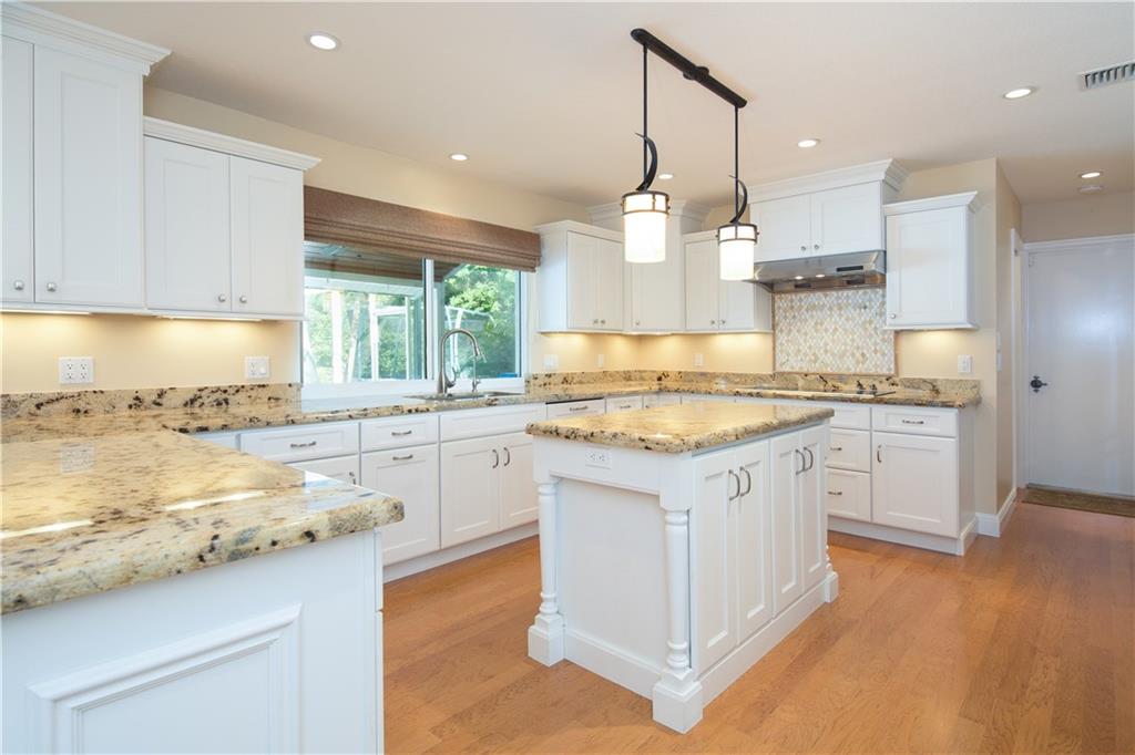 171 South Sewalls Point Road Stuart, FL 34996 - Photo 6 of 34 a kitchen with granite countertop white cabinets and white appliances