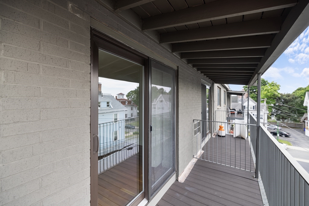 134 Summer Street, Unit 37 Malden, MA 02148 - Photo 3 of 10 a view of a balcony with wooden floor