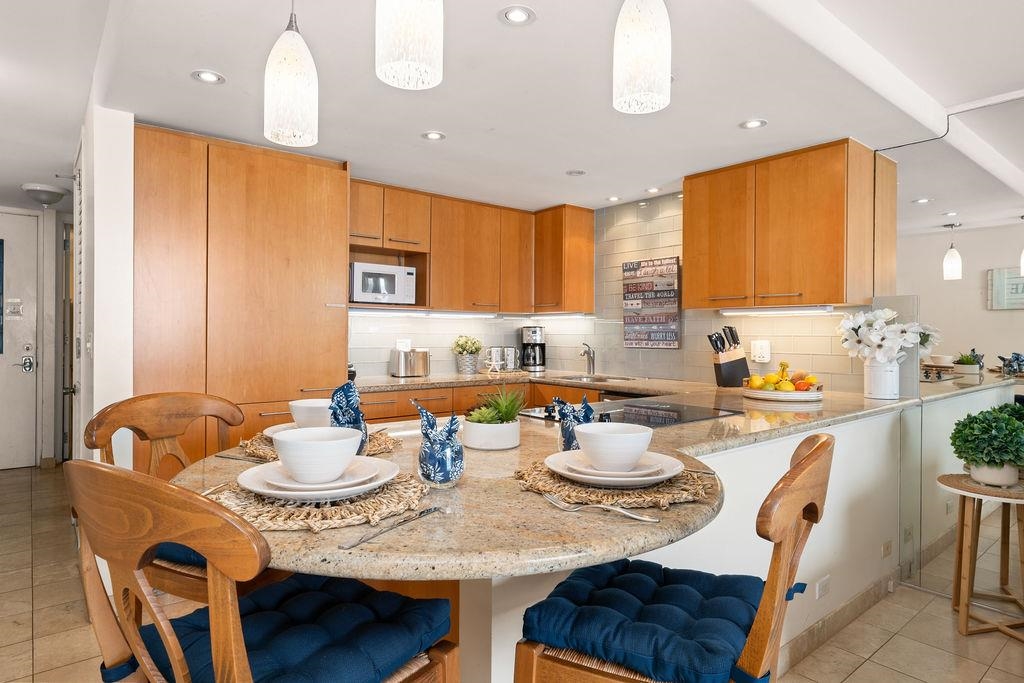 3785 Lower Honoapiilani Road, Unit 208 Lahaina, HI 96761 - Photo 14 of 50 a dining room with furniture a window and a table
