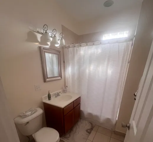 a bathroom with a sink toilet and mirror