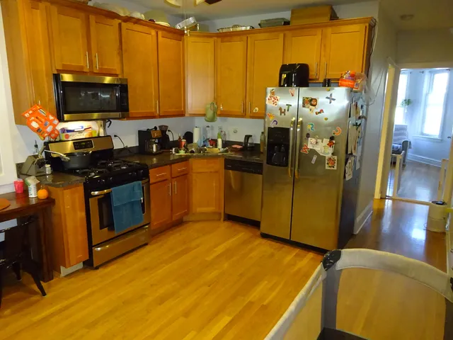 a kitchen with stainless steel appliances a stove a sink and a microwave