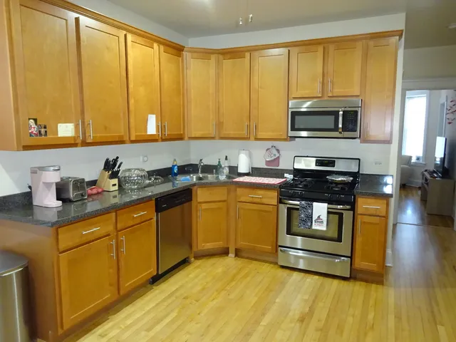 a kitchen with stainless steel appliances a stove sink and microwave