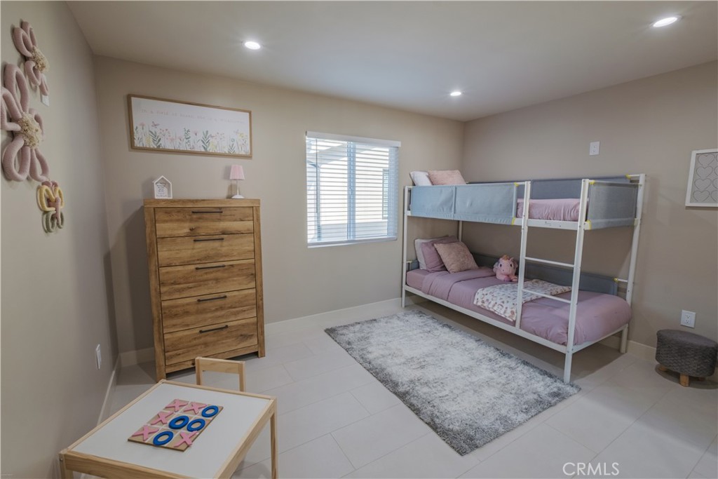 223 South Aprilia Avenue Compton, CA 90220 - Photo 35 of 46 a bedroom with a bed and a window
