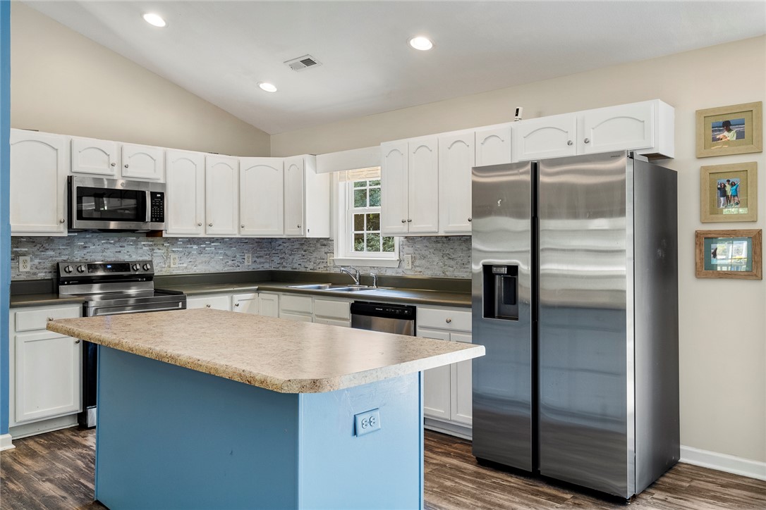 167 Mediterranean Avenue Anderson, SC 29621 - Photo 14 of 33 A vibrant kitchen island anchors this well-lit space, complemented by modern stainless steel appliances.
