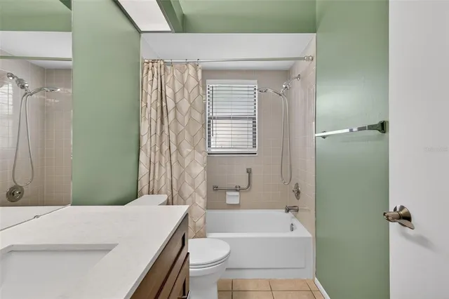 a bathroom with a sink a toilet a bathtub and shower