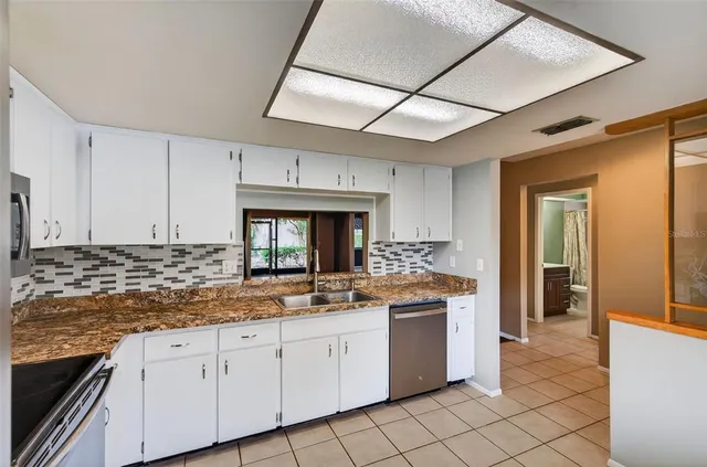 a kitchen with a sink stove and cabinets