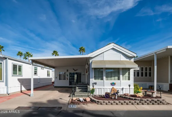 a front view of a house with outdoor seating