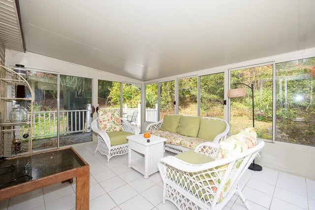 a living room with furniture and a floor to ceiling window