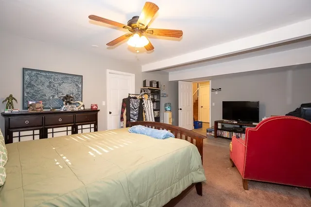 a bed room with a bed and a chair