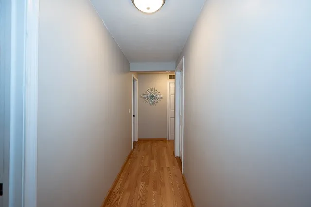 a view of a room with wooden floor