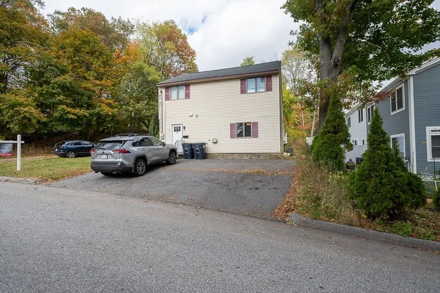 a front view of a house with a yard and deck