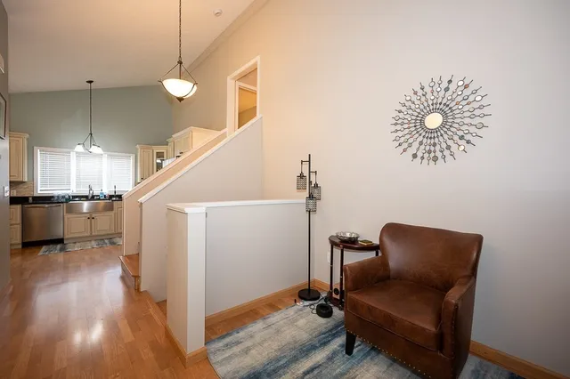 a view of a hallway with workspace and wooden floor