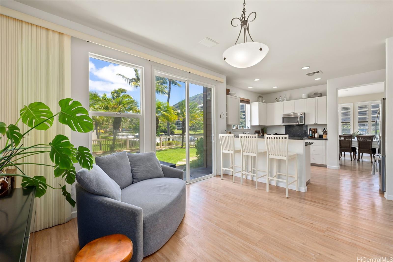 520 Lunalilo Home Road, Unit 310 Honolulu, HI 96825 - Photo 11 of 23 Another view of the den looking towards the kitchen and dining area in the background. This shows a better view of the grassy enclosed backyard